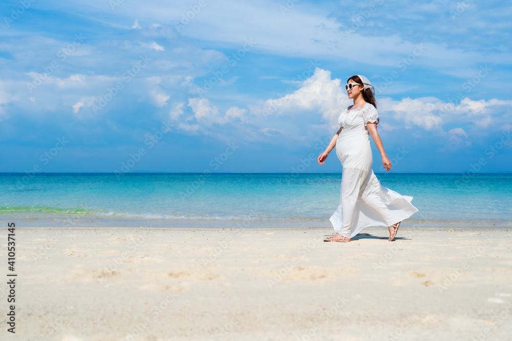 pregnant woman walking on the sea beach at Koh MunNork Island, Rayong, Thailand pregnant woman walking on the sea beach at Koh MunNork Island, Rayong, Thailand