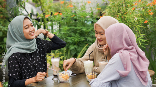 Asian group hijab woman smilling in cafe with friend