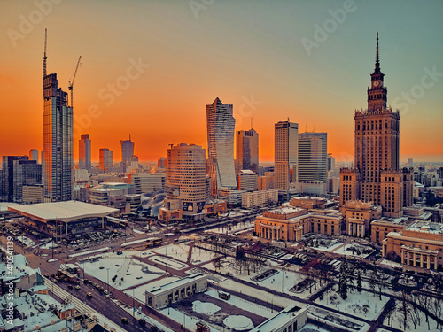 Beautiful panoramic aerial drone view on Warsaw City Skyscrapers, PKiN, and Varso Tower under construction and 19th-century tenement houses during the January sunset, Warsaw, Poland.