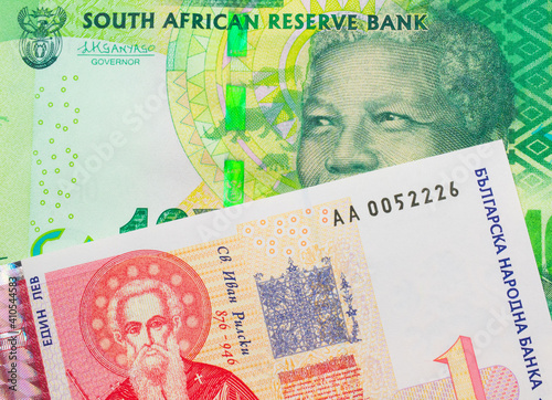 Wallpaper Mural A macro image of a shiny, green 10 rand bill from South Africa paired up with a red and white one lev bank note from Bulgaria.  Shot close up in macro. Torontodigital.ca