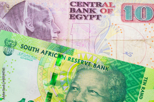 Wallpaper Mural A macro image of a shiny, green 10 rand bill from South Africa paired up with a pink and purple ten pound bank note from Egypt.  Shot close up in macro. Torontodigital.ca