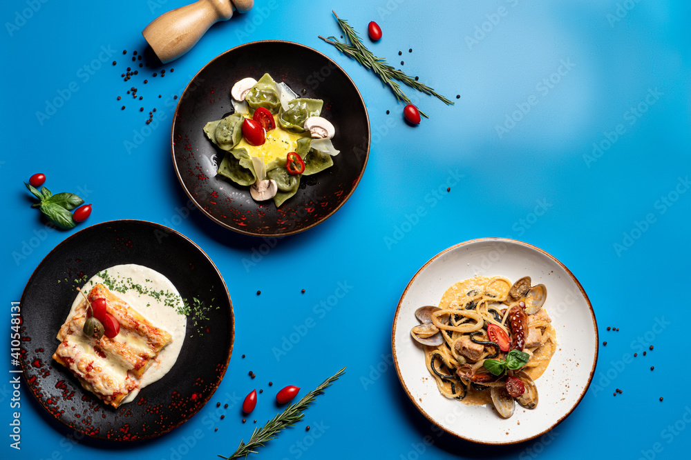 Menu of italian restaurant on a bright blue background, top view, studio photography