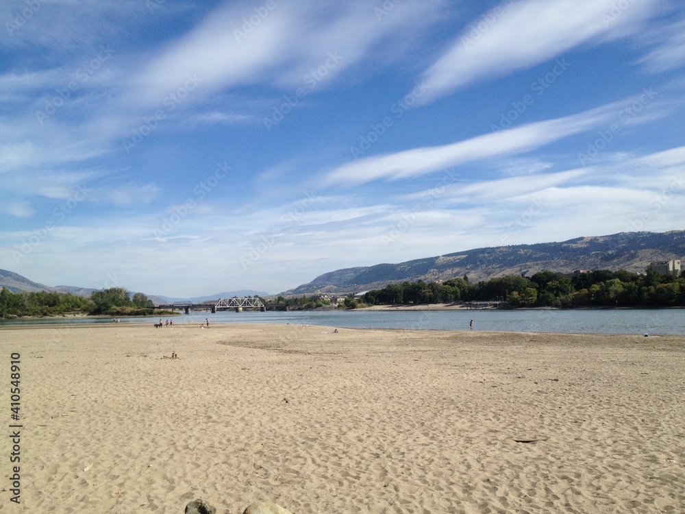 The sandy river bank of the North Thompson river in the beautiful dry landscape of Kamloops, British Columbia, Canada.  A great spot for locals walk go swimming.
