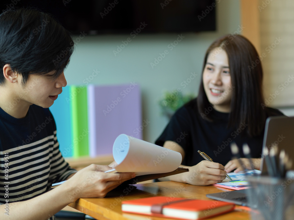 Two office worker working with paperwork on clipboard in office room