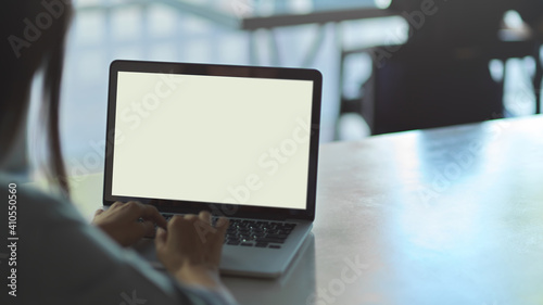 Close up view of business female typing on laptop keyboard on the table