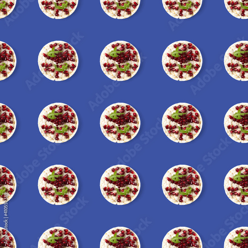Seamless pattern from galettHealthy breakfast with rice cake and pomegranate on violet flat lay.