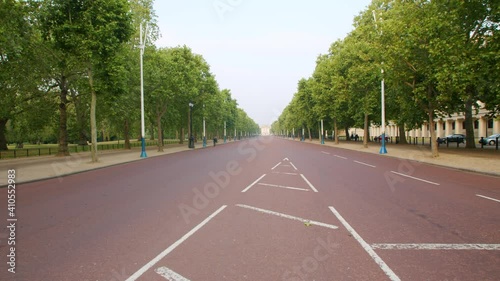 Lockdown in London, lone person cycles along The Mall deserted in Westminster, on sunny day, during the COVID-19 pandemic 2020. photo