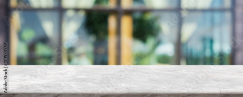 Empty white marble stone table top and blur glass window interior cafe and restaurant banner mock up abstract background - can used for display or montage your products.