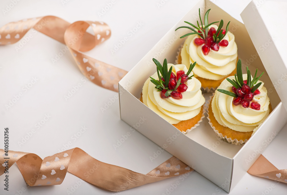 Valentines cupcakes with vanilla icing in a box on a white background Valentines cupcakes with vanilla icing in a box on a white background