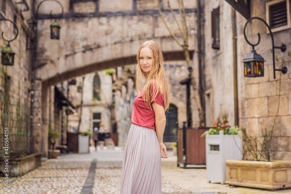 Young woman tourist walks down the street in a European city after the end of COVID-19 coronavirus. quarantine is over