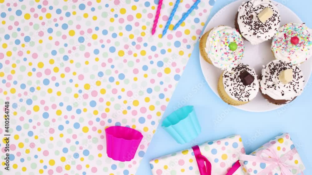 Hand take one cup cake with cream from the plate. Stop motion Hand take one cup cake with cream from the plate. Stop motion