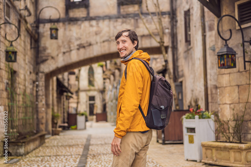 Young man tourist walks down the street in a European city after the end of COVID-19 coronavirus. quarantine is over