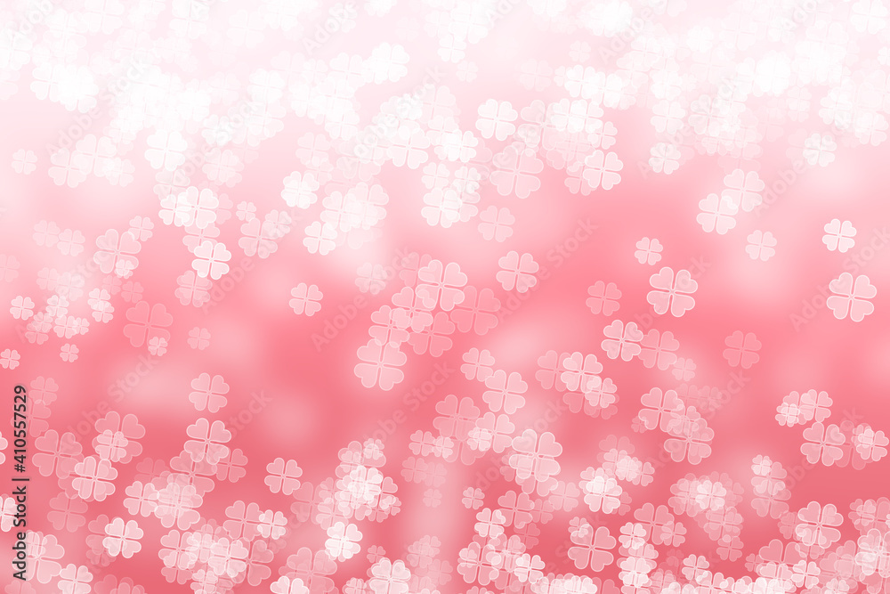 Abstract bokeh background with four leaf clover pattern in pink colour