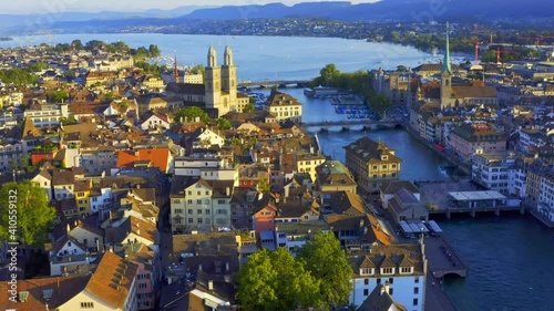 An aerial view of the Grossmünster and the Fraumünster on the banks of the Limmat River in Switzerland, full shot photo