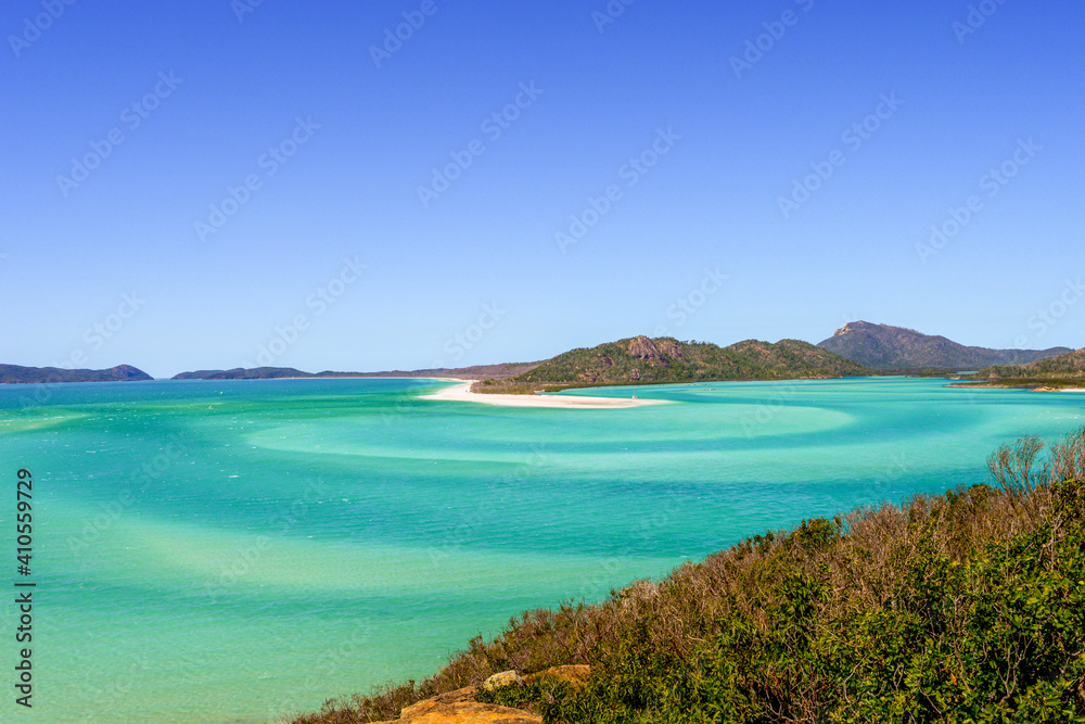 Panorama of iconic and amazingly beautiful Whitehaven Beach in the Whitsunday Coast, Queensland taken in summer time on a beautiful blue sky day. 