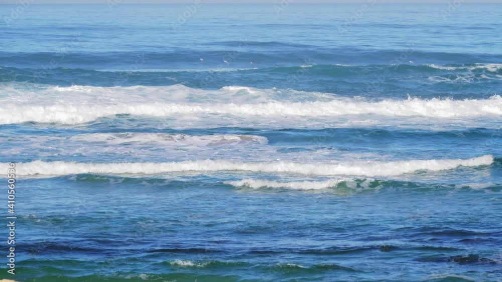 High angle view of the beautiful rolling waves on the sea in Spain, with birds flying in the sky High angle view of the beautiful rolling waves on the sea in Spain, with birds flying in the sky