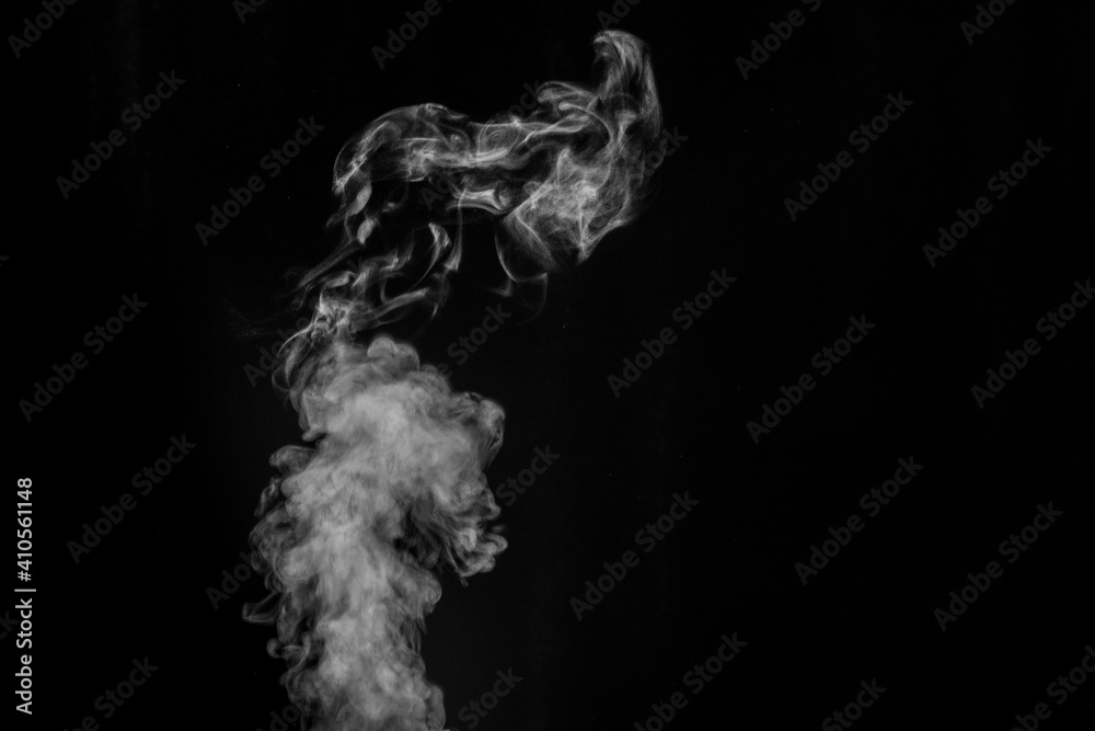 White smoke on black background. Figured smoke on a dark background. Abstract background, design element, for overlay on pictures
