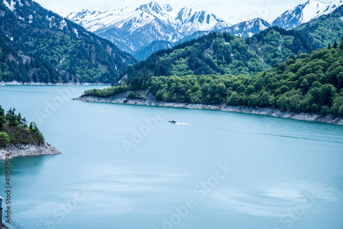 Beautiful lake, ferry and mountain in Kurobe dam, Toyama, Japan