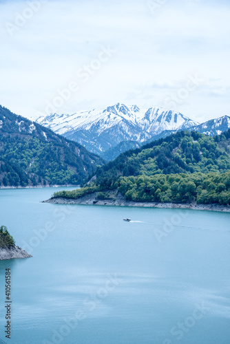 Beautiful lake, ferry and mountain in Kurobe dam, Toyama, Japan