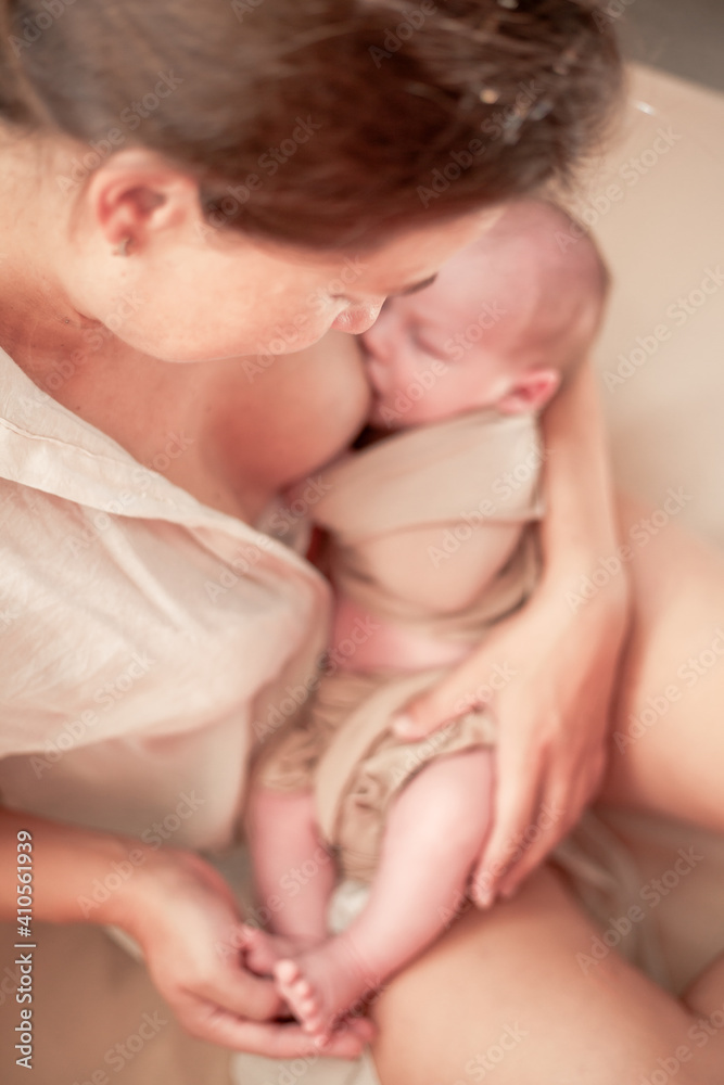 Mother holding newborn baby and breastfeedidiing little infant kid in hands Mother holding newborn baby and breastfeedidiing little infant kid in hands