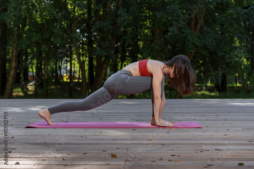 Young woman doing yoga in the morning park © Елена Гурова