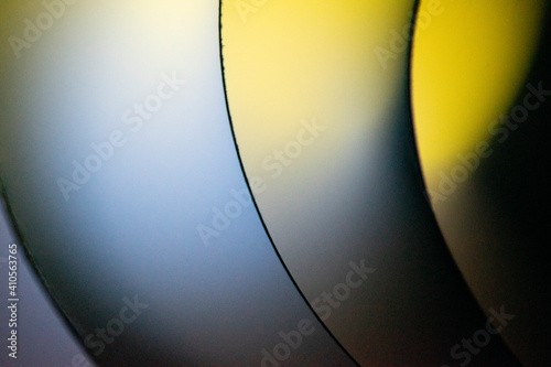Background macro image pattern made of folded curved sheets of paper with multi color light illuminate  
