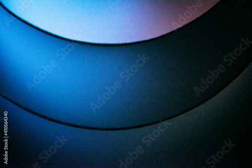 Background macro image pattern made of folded curved sheets of paper with multi color light illuminate  