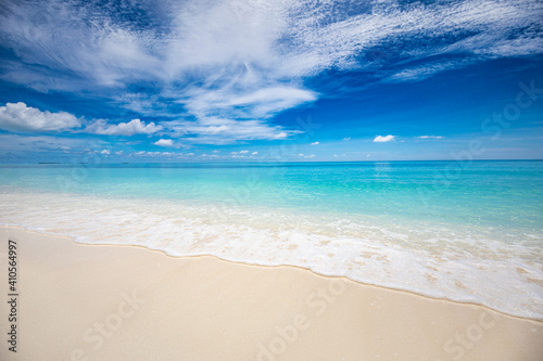 Closeup of sand on beach and blue summer sky. Panoramic beach landscape. Empty tropical beach and seascape. Blue sky, soft sand, calmness, tranquil relaxing sunlight, summer mood. Travel vacation