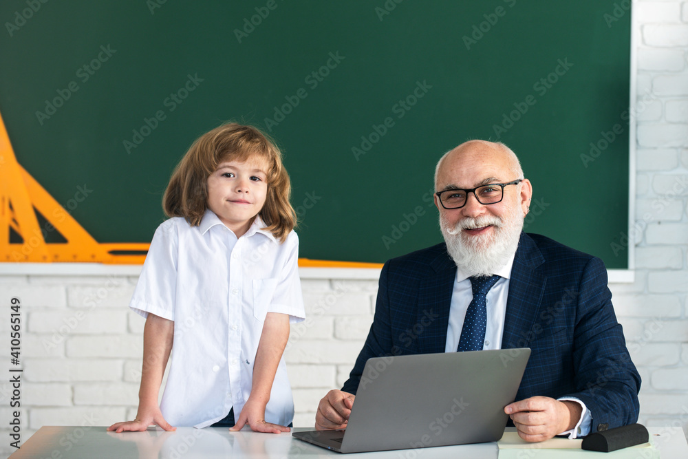 Teacher and child. Back to school. Education and learning in school. Schoolboy in classroom. Old teacher and young pupil. Teacher and child. Back to school. Education and learning in school. Schoolboy in classroom. Old teacher and young pupil.