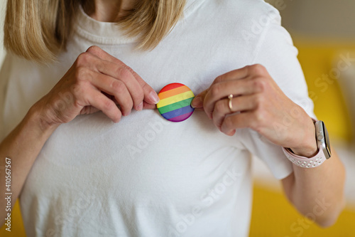Stylish Woman in white shirt with the LGBT pride flag sign. Concept of the Pride day, Valentine day, freedom, love. Flat lay, top view, template, overhead