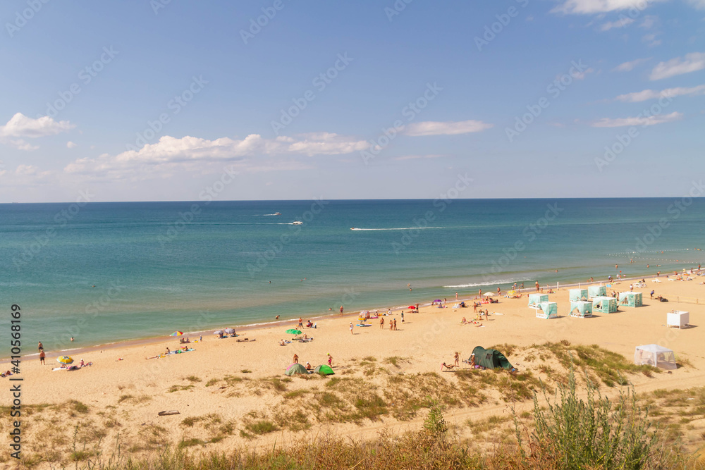 view of the beach on the black sea coast. Summer vacationers at the sea.