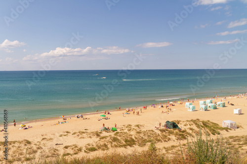 view of the beach on the black sea coast. Summer vacationers at the sea. © Olga