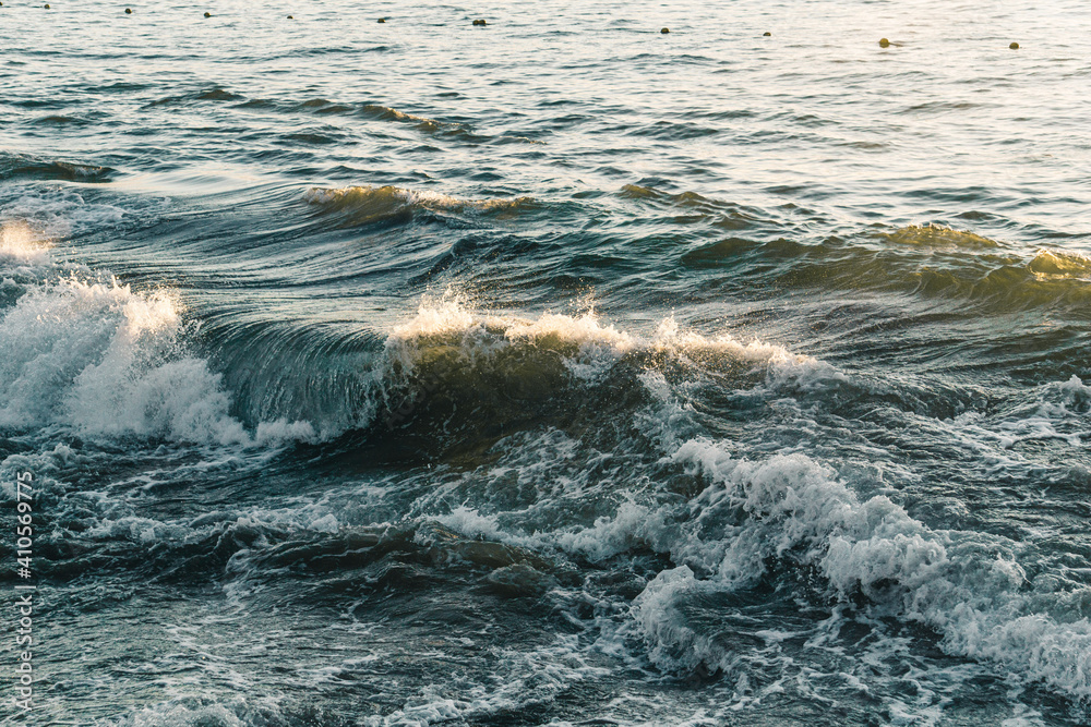 Fototapeta premium BACKGROUND OF WAVES AND SEA AT SUNSET