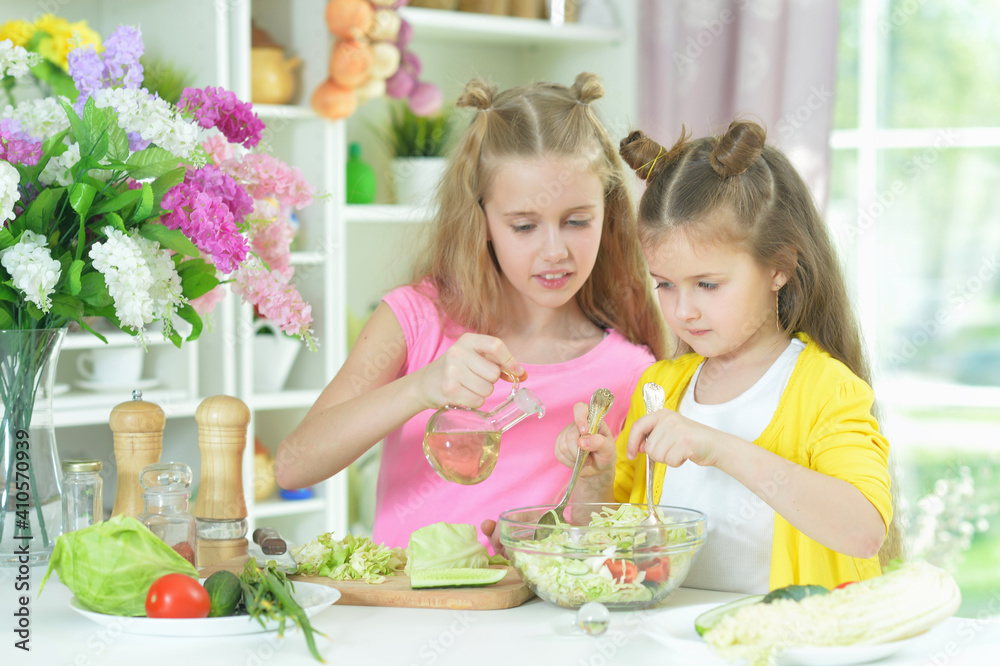 Cute girls preparing delicious fresh salad