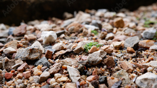 Small rocks mixed with sand on the ground.