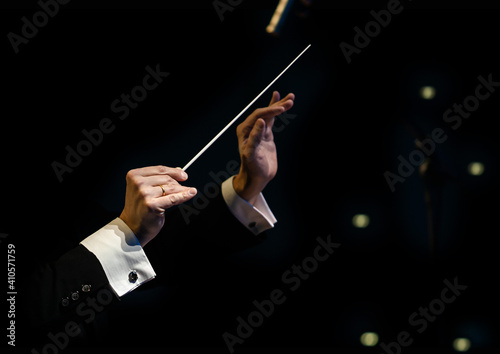  Hands of the conductor of a symphony orchestra closeup