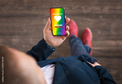 Man using gay and LGBT community dating app on his mobile phone