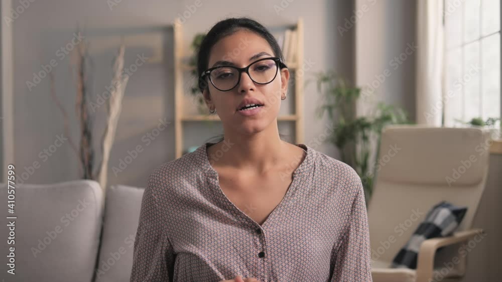 young woman talking to the camera in video conference chat,mixed-race female coach leader speaking during an online meeting webcast working from home,internet training concept