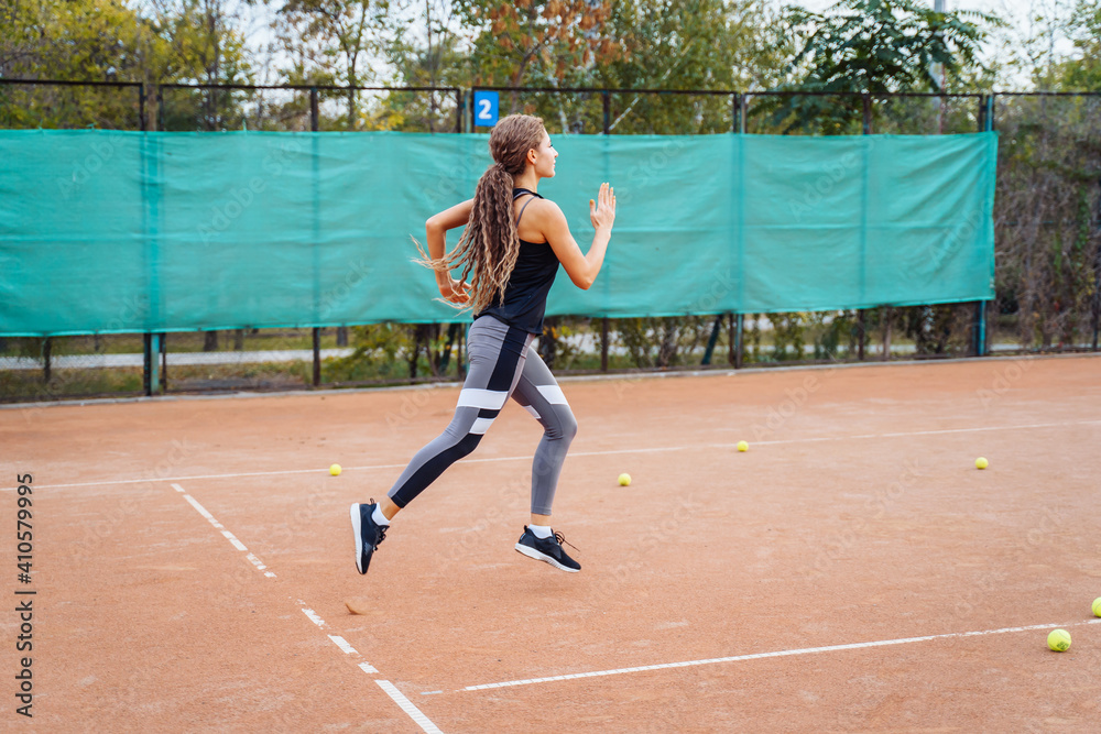 Obraz premium Qualitative warm-up. Warming up your muscles before an intense tennis workout on the court. Preparatory steps for an important tennis match. Sports exercises to help tone muscles