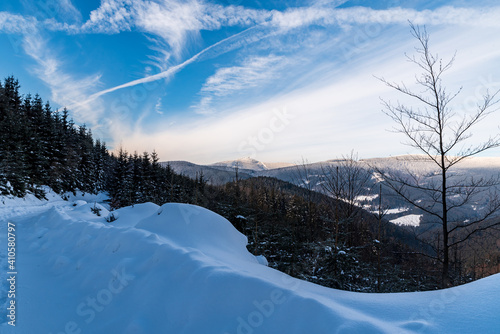 Lysa hora and Travny hills from forest road bellow Misaci hill summit in winter Moravskoslezske Beskydy mountains in Czech republic photo