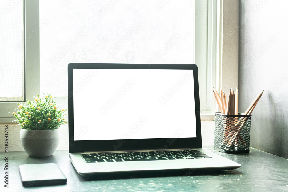 Fototapeta premium Laptop computer with mockup or blank screen on desk in workspace and copy space concept
