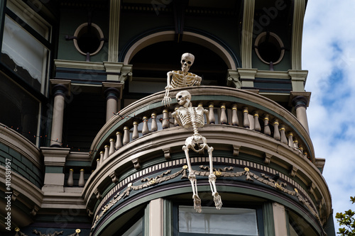 Photography Low angle shot of the human skeleton hanging on the balcony in the San Francisco