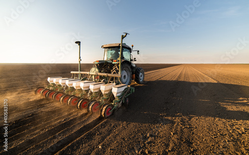 Fotografija Farmer with tractor seeding