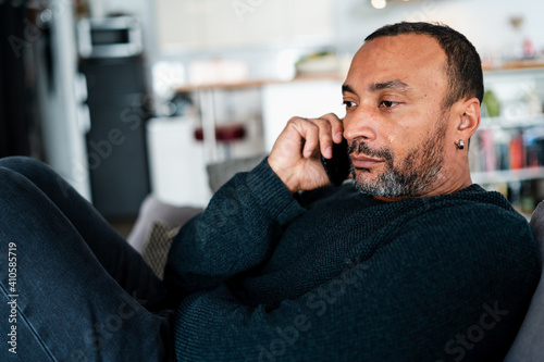 Depressed 40 years old man talking on the phone