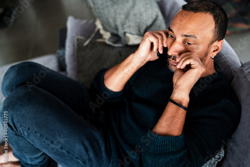Depressed 40 years old man talking on the phone