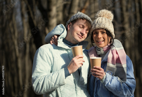 couple in the park. Coffee cups. Love couple. Smiling man and woman. 