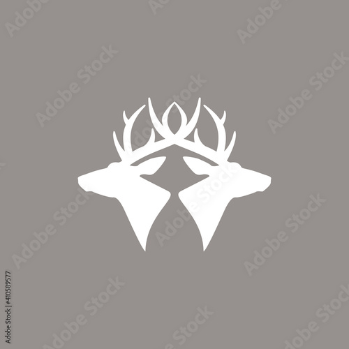 two deer heads logo. vector flat silhouette isolated on beige background. Wild animal symbol.