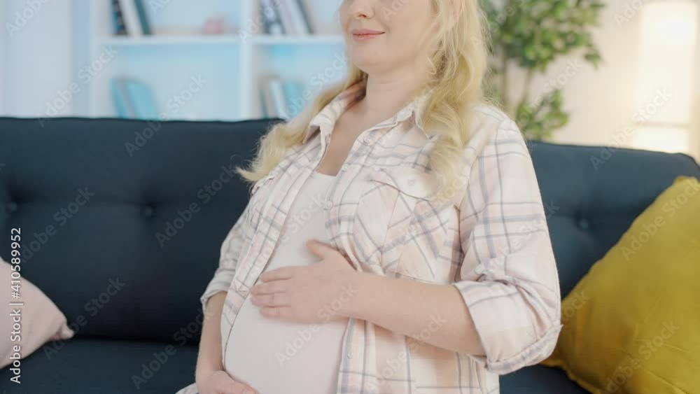 Calm female touching belly, expecting baby, happiness of pregnancy, childbirth Calm female touching belly, expecting baby, happiness of pregnancy, childbirth