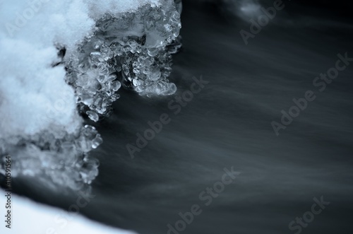 clean ice shapes with freezing river stream underneath