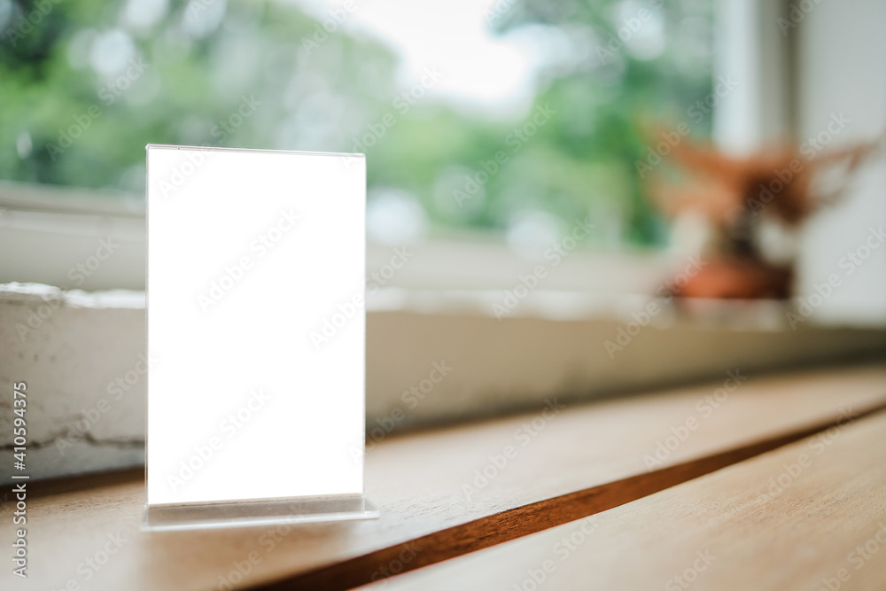 Mock up Menu frame standing on wood table in Bar restaurant cafe. space for text.